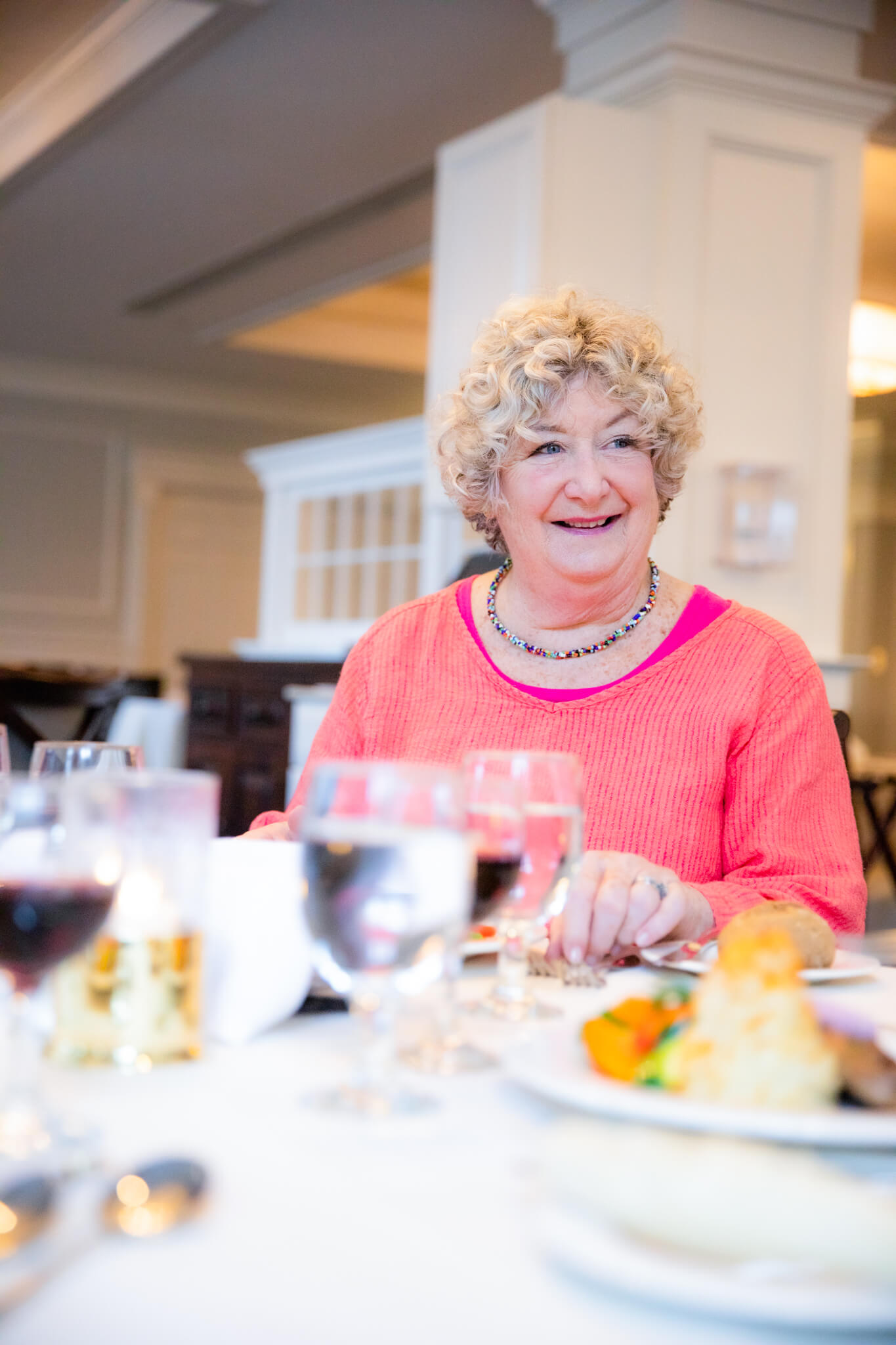 Lynn Stroud Sitting at a Dinner Table