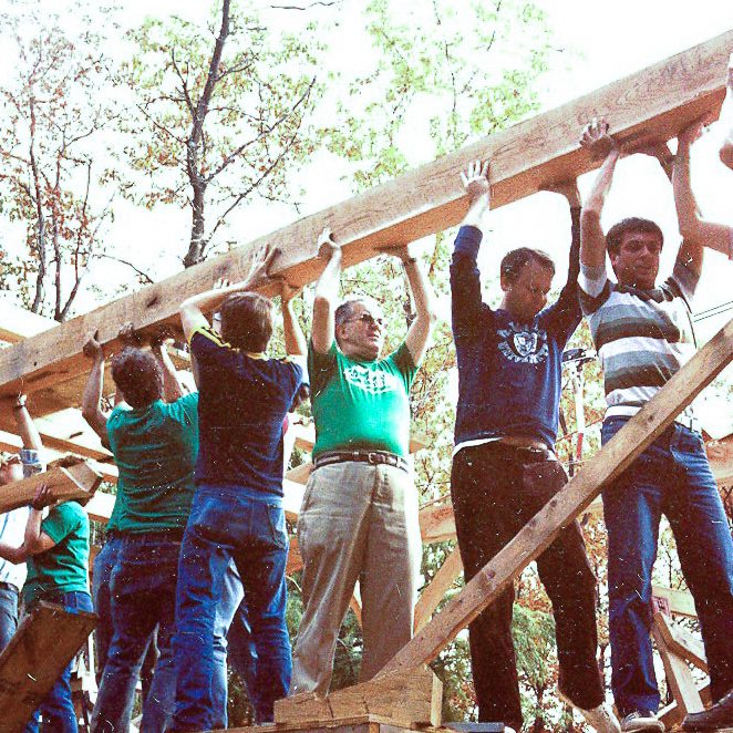 Men Holding a Beam