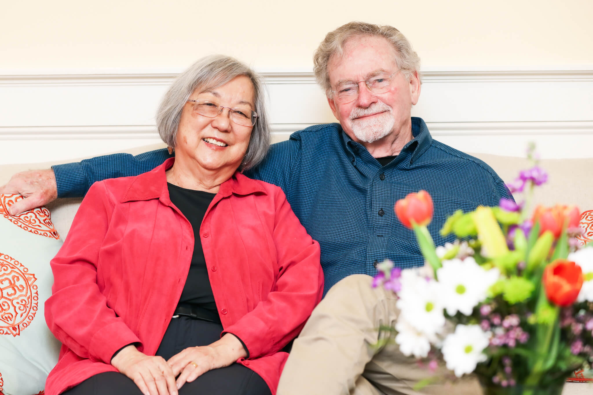 Margie Yamamoto and Mark Hopkins Sitting on Couch