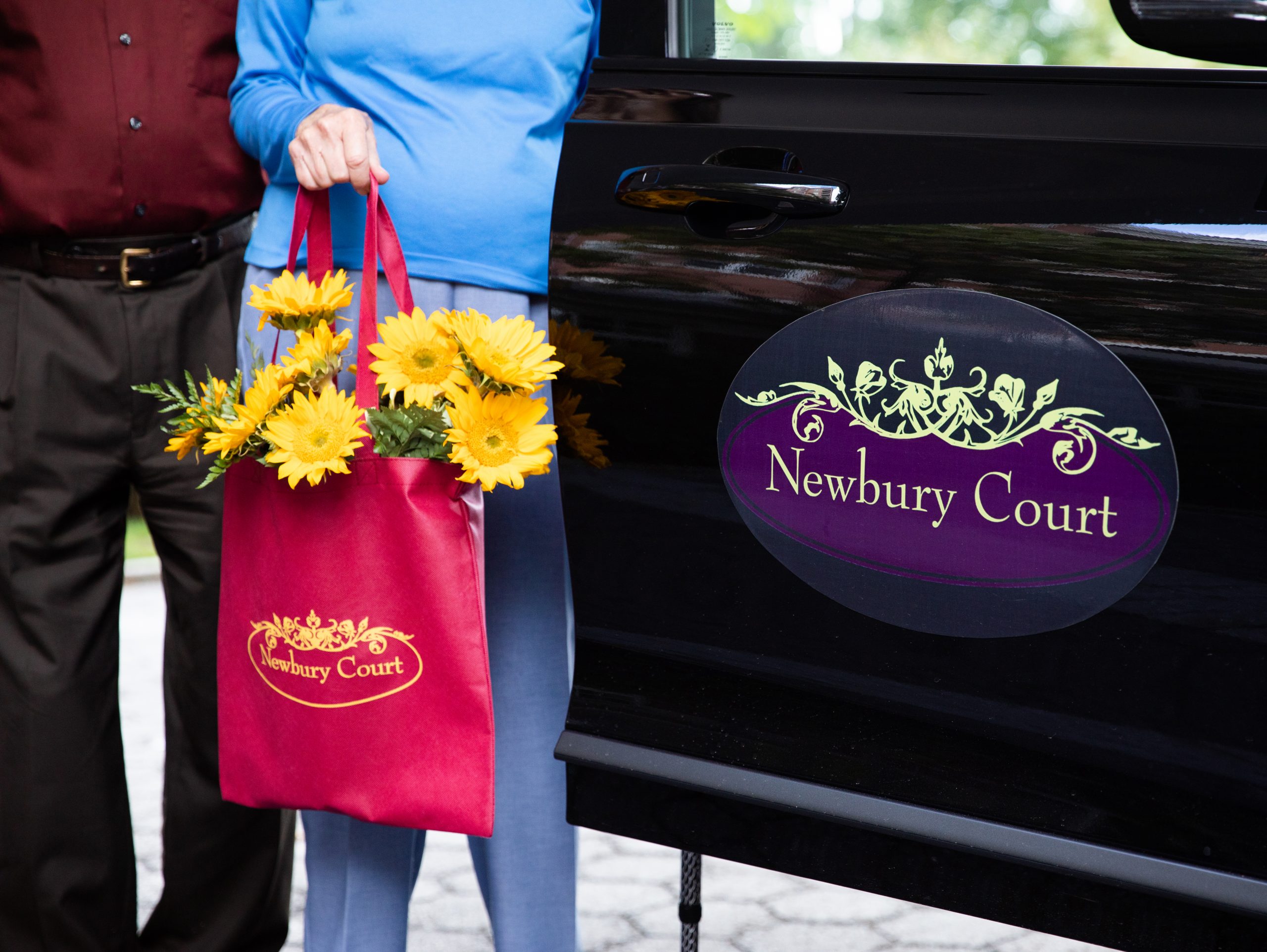 Couple with Flowers Leaving Newbury Court Transportation Vehicle